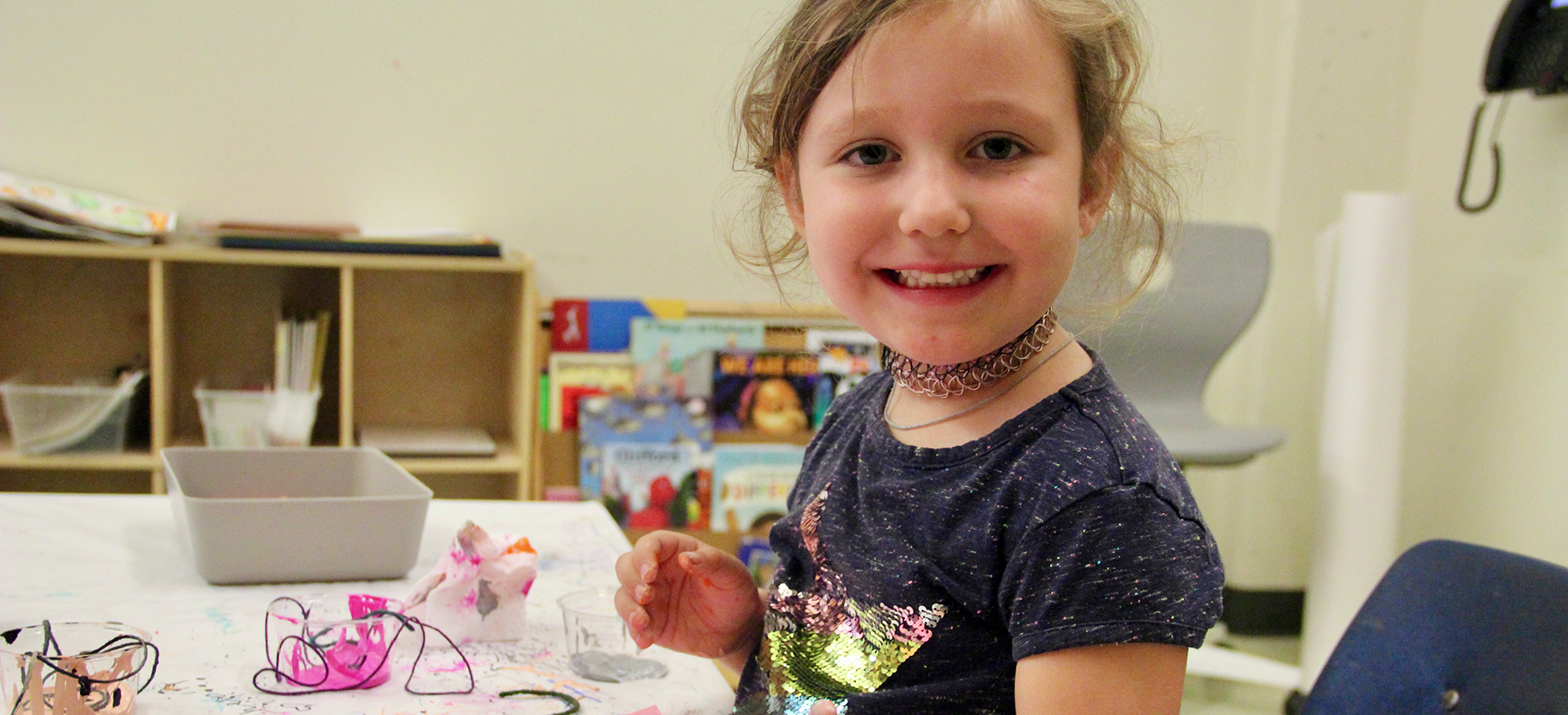 Girl smiling and making art