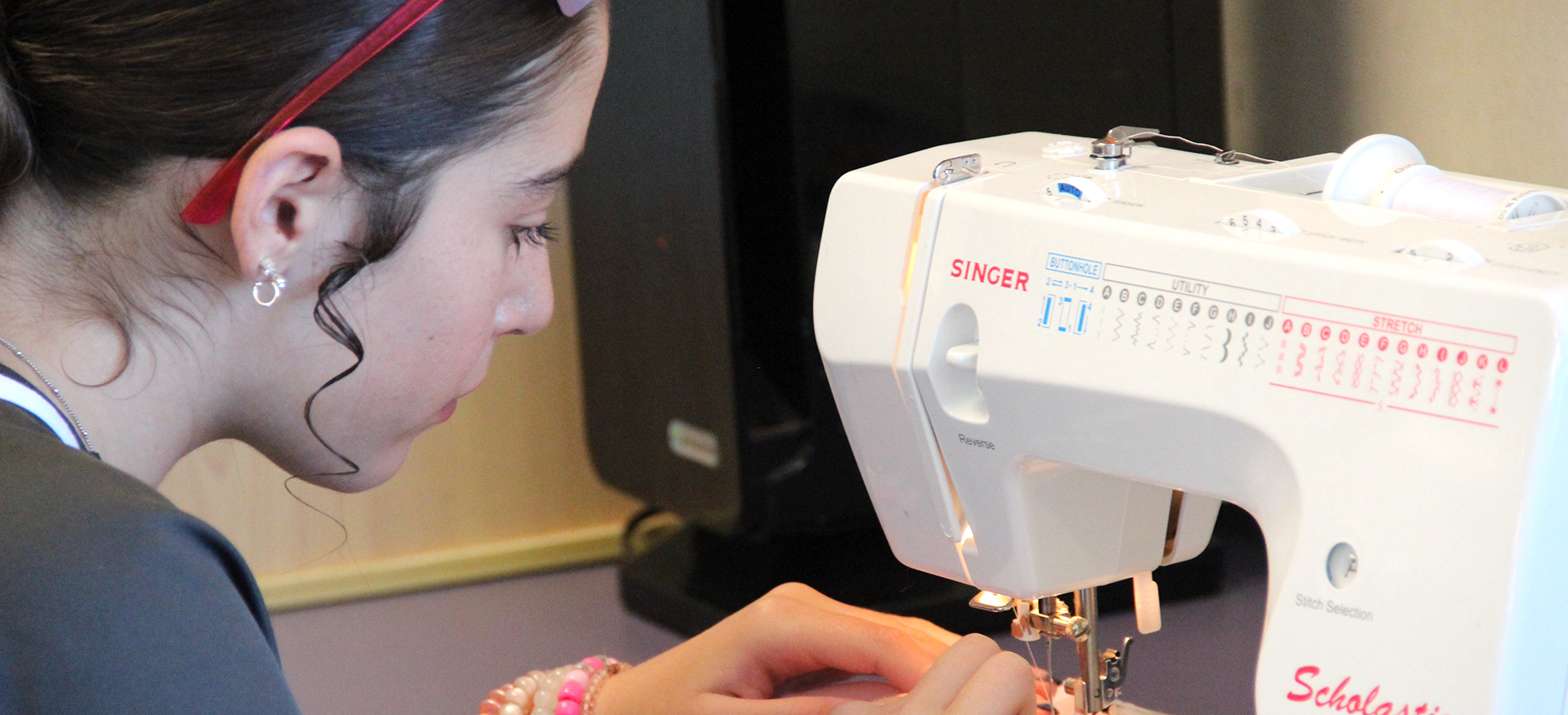 Girl sewing a garment