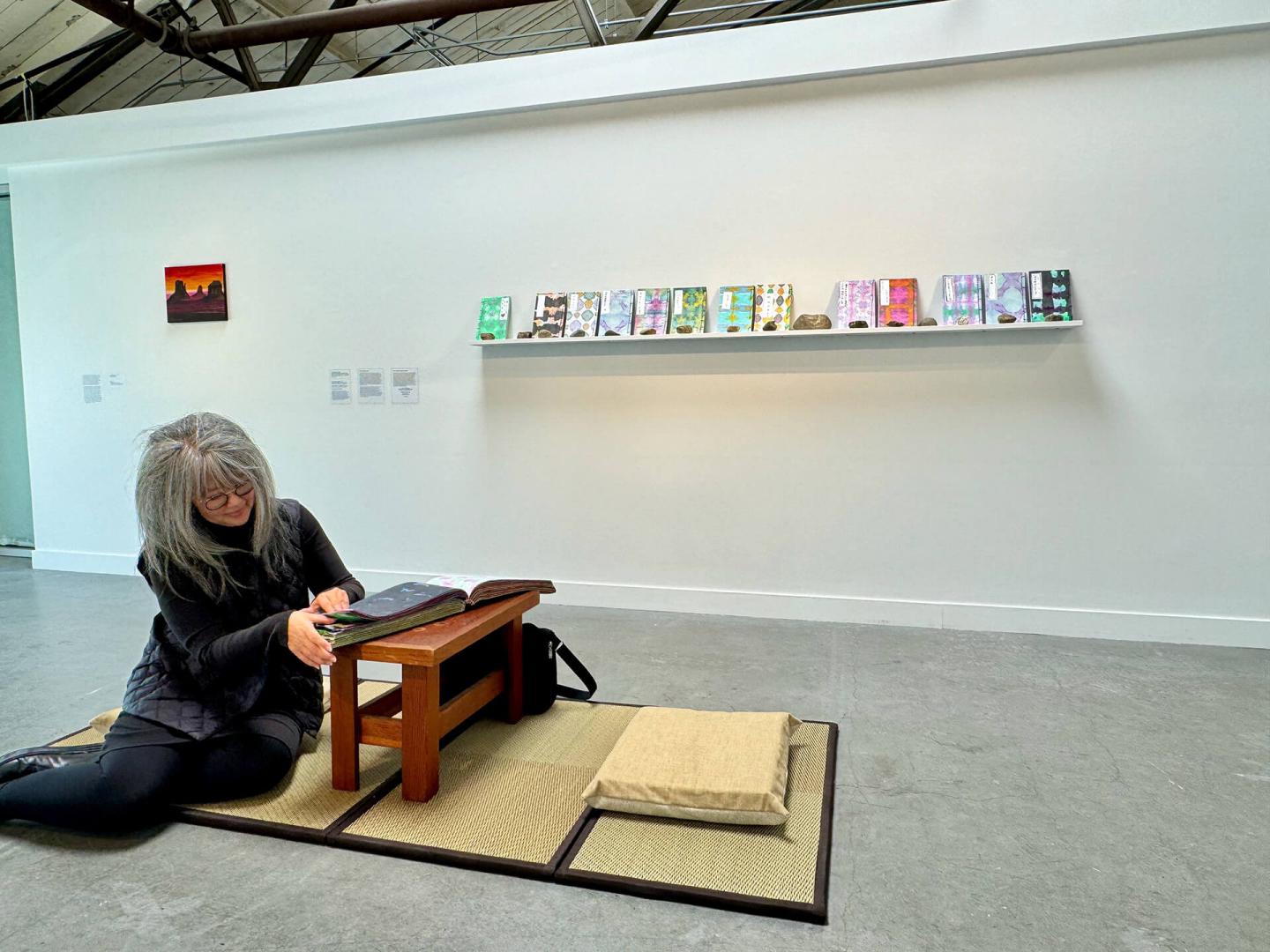 Woman sitting in gallery